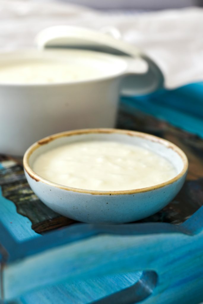 Bowl of homemade Greek yogurt on a blue tray