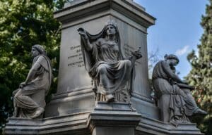 Bronze statues of ancient figures, with engraved inscriptions.