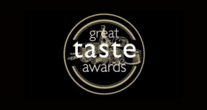 Logo officiel des Great Taste Awards sur fond noir