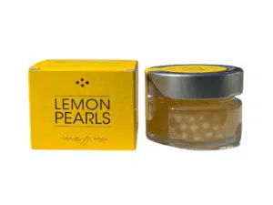 Pot de 50 ml de perles de vinaigre balsamique au citron Messino, à côté de sa boîte jaune
