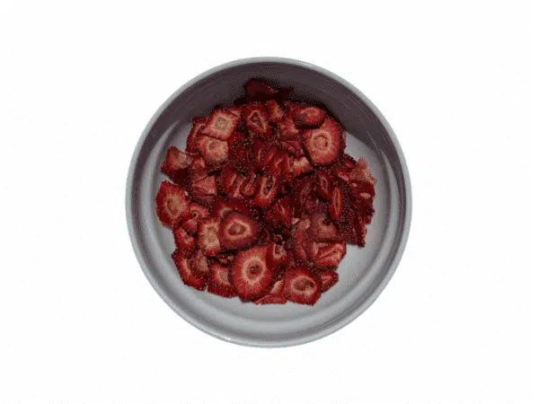Homemade dried Greek strawberry slices in a white bowl