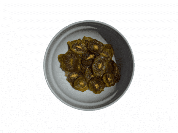Homemade dried Greek kiwi slices in a white bowl