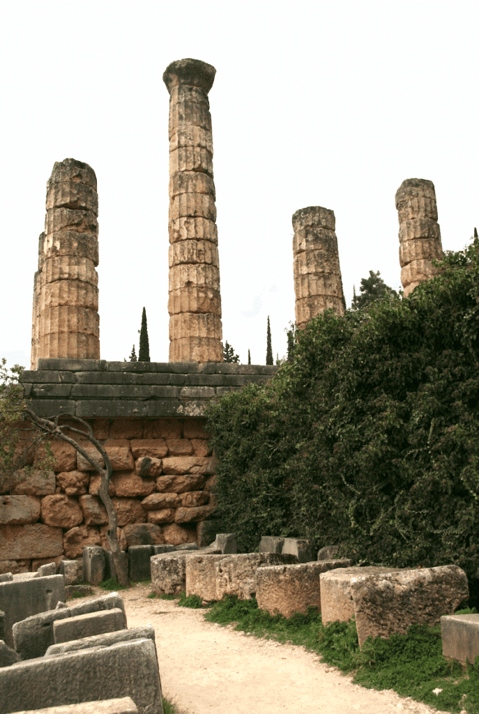 Stone columns from the temple of Apollo at Delphi, partially preserved among the archaeological remains.