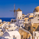 Emblematic view of Santorini with windmills and white houses overlooking the Aegean Sea