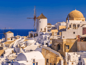 Emblematic view of Santorini with windmills and white houses overlooking the Aegean Sea