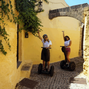 Segway tour of Rhodes with two participants in an alleyway.