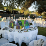 Open-air painting workshop in Athens with exhibited canvases and participants