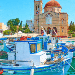 Picturesque harbor on the island of Aegina with colorful boats and the main church on the waterfront, Greece.
