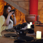 Dégustation de vin antique dans la salle des vignerons à Athènes, avec des participants et des récipients en terre cuite.