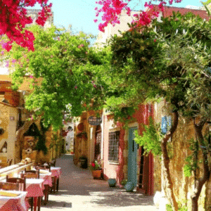 Picturesque alleyway in Chania, Crete, with restaurants and tables on the terrace
